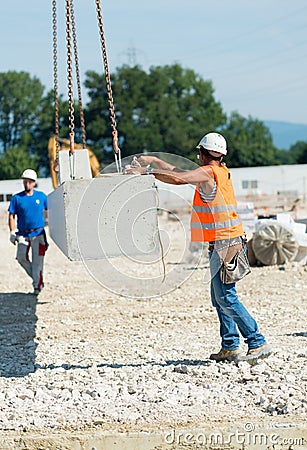 Workers operating in contruction building site Editorial Stock Photo