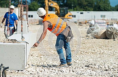 Workers operating in contruction building site Editorial Stock Photo