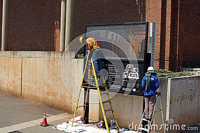 Workers painting a sing on Constitution Hill Editorial Stock Photo