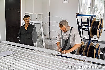 Workers at the plant for the production of plastic Windows in the Kaluga region in Russia. Editorial Stock Photo