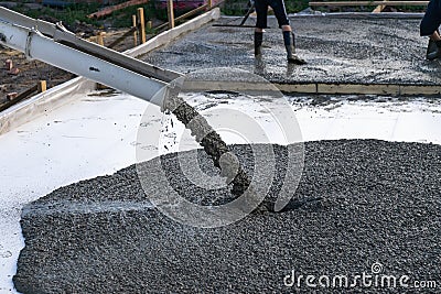 Workers pour the Foundation for the construction of a residential building using mobile concrete mixers. Stock Photo