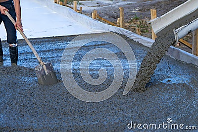 Workers pour the Foundation for the construction of a residential building using mobile concrete mixers Stock Photo