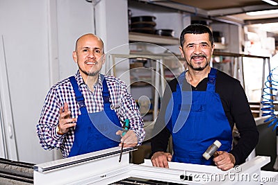 Workers with PVC windows and doors Stock Photo