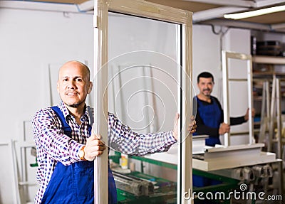 Workers with PVC windows and doors Stock Photo