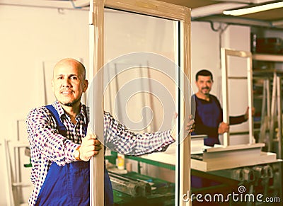 Workers with PVC windows and doors Stock Photo