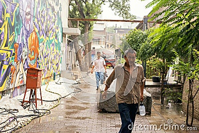 Workers in the rain Editorial Stock Photo