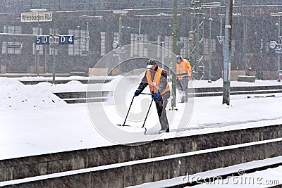 Workers removing snow from the station platform Editorial Stock Photo