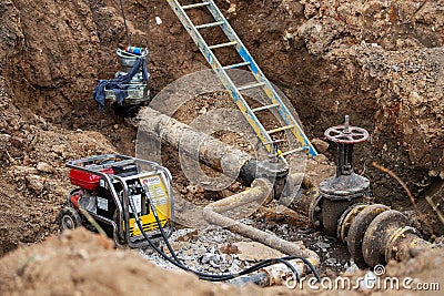 Workers of the repair team excavated pipeline Stock Photo