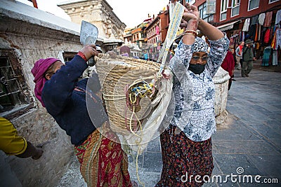 Workers repairing of Stupa Boudhanath, Dec 3, 2013 in Kathmandu, Nepal. Stupa is one of the largest in the world Editorial Stock Photo