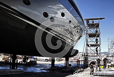 Workers repairing a boat in a scaffold. Editorial Stock Photo
