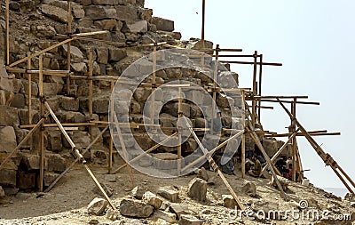 Workers restoring a corner section of the Bent Pyramid at Dahshur in Egypt take a rest break. Editorial Stock Photo