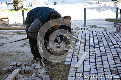 Workers setting up pavements Editorial Stock Photo