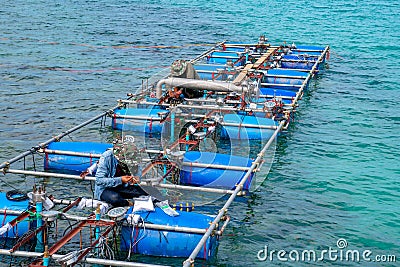 Workers settle and setup the waterworks fountain machine on the surface of the sea Editorial Stock Photo