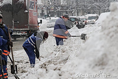 Workers shovel snow Editorial Stock Photo