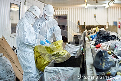 Workers sorting recyclable materials at waste processing plant Stock Photo