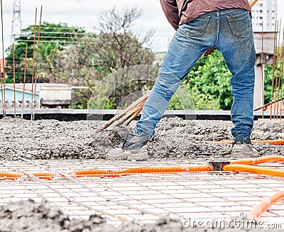 Workers spreading concrete over the slab Stock Photo