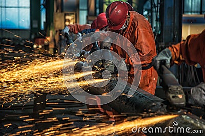 The workers in the steel mill are burnishing the steel Editorial Stock Photo