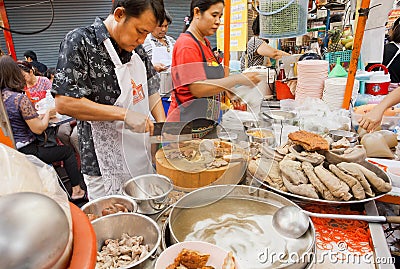 Workers of street restaurant cooking meat dishes outdoor Editorial Stock Photo