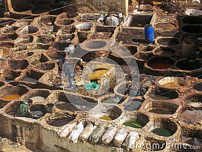 Workers tanning and dyeing hides in the casbah of Fez, one of the most beautiful Moroccan cities Editorial Stock Photo