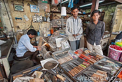 Workers of the turning shop and knife store on market street Editorial Stock Photo