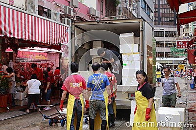 Workers unload food from refrigerated truck Editorial Stock Photo