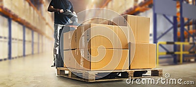 Workers Unloading Packaging Boxes on Pallet in The Warehouse. Cardboard Boxes. Shipping Supplies Warehouse. Shipment Boxes. Stock Photo