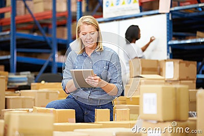 Workers In Warehouse Preparing Goods For Dispatch Stock Photo