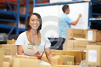 Workers In Warehouse Preparing Goods For Dispatch Stock Photo