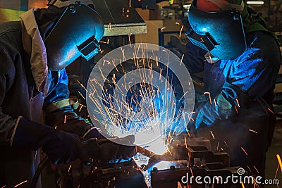 Workers are welding assembly car parts in automotive industrial factory Stock Photo