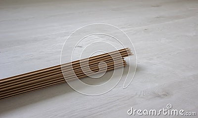 Workers' hands install a wooden laminate floor. Home renovation with wooden floors with measurements Stock Photo