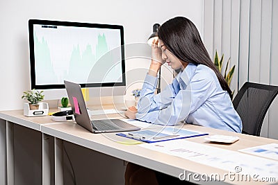 Working Asian women feel stressed, tired from work, migraine headaches from hard work while working at the office Stock Photo