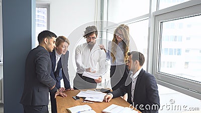 Working atmosphere in the office. employees to view documents in the workplace. group of business people discussing Stock Photo