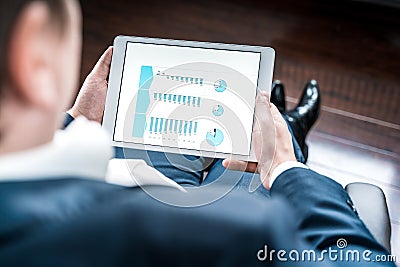 Working businessman investor,trader.Financial report,presenatation in tablet.Diagram gantt chart, analytics,project profit Stock Photo