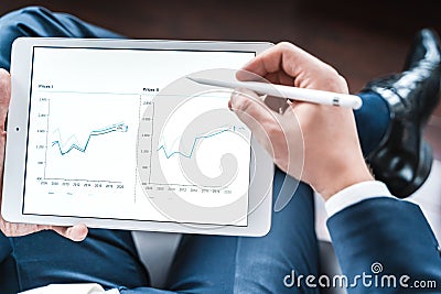 Working businessman investor,trader.Financial report,presenatation in tablet.Diagram gantt chart, analytics,project profit Stock Photo