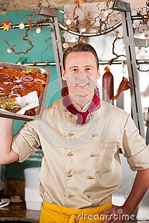 Working in butchers shop with barbeque meat Stock Photo