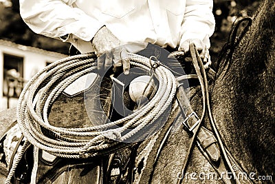 Working Cowboy Riding with Rope - Sepia Tint Stock Photo