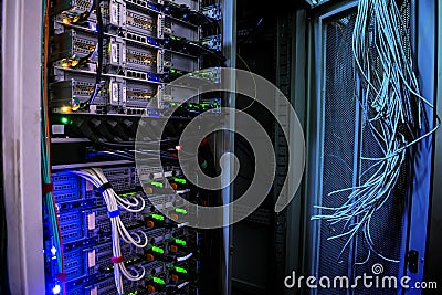 Working and empty racks with server equipment are in the data center. Many connected and disconnected cables are in the computer Stock Photo