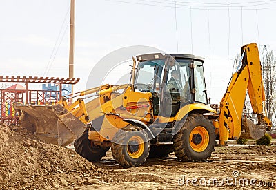 Working excavator tractor digging a trench at construction site Editorial Stock Photo
