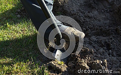 Working in the garden - spade foot boot Stock Photo
