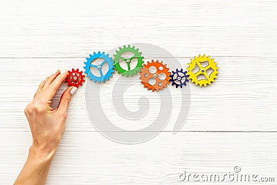 Working gears cogwheels mechanism in hand. Business problem solution and teamwork concept Stock Photo