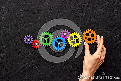 Working gears cogwheels mechanism in hand. Business problem solution and teamwork concept Stock Photo