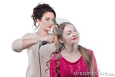 Working hairstylist and blond woman Stock Photo