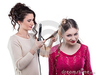 Working hairstylist curling client Stock Photo