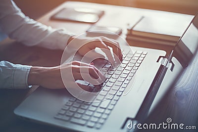 Working at home with laptop woman writing a blog. Female hands on the keyboard Stock Photo