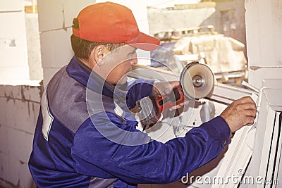 Working installation plastic window working saws building a house Stock Photo