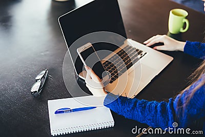 Working lady at laptop and phone Stock Photo