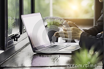 Working on laptop, close up of hands of business man Stock Photo