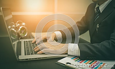 Working on laptop, close up of hands of business man Stock Photo