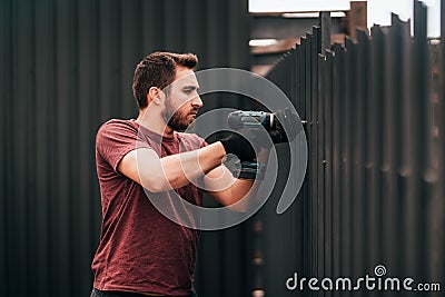 Working man portrait - construction worker using screwdriver and installing elements Stock Photo