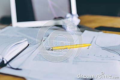 Working mess with crumpled papers, laptop and different papers on wooden table. Stock Photo